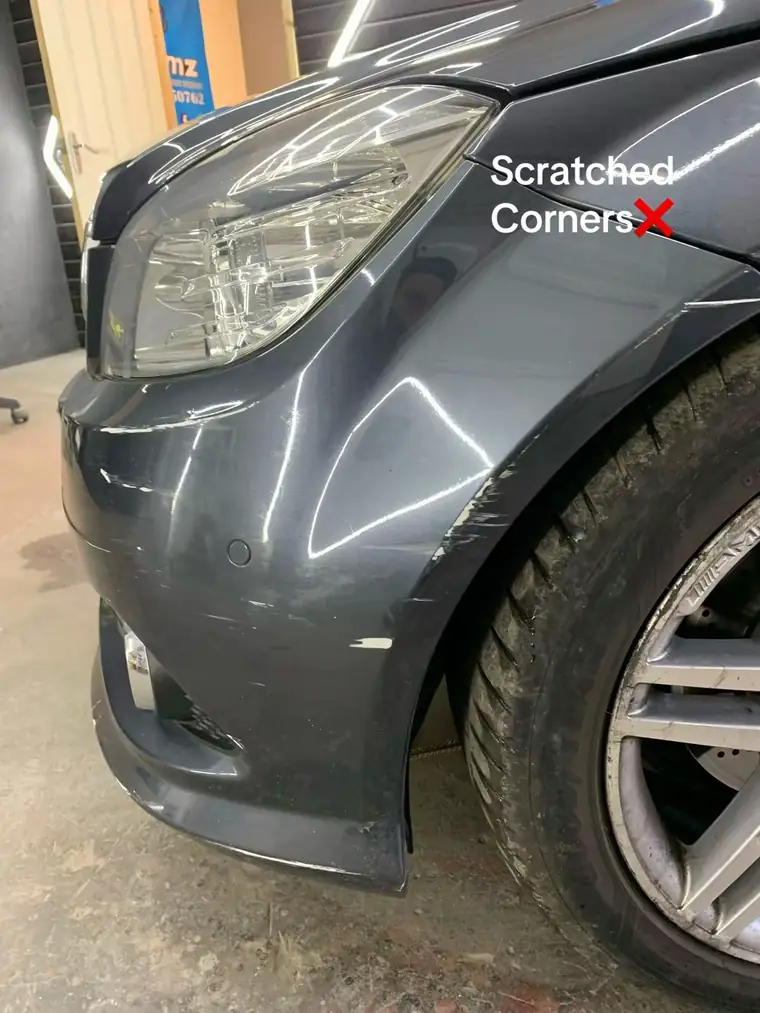 Scratched and scuffed front corner of a grey Mercedes C220