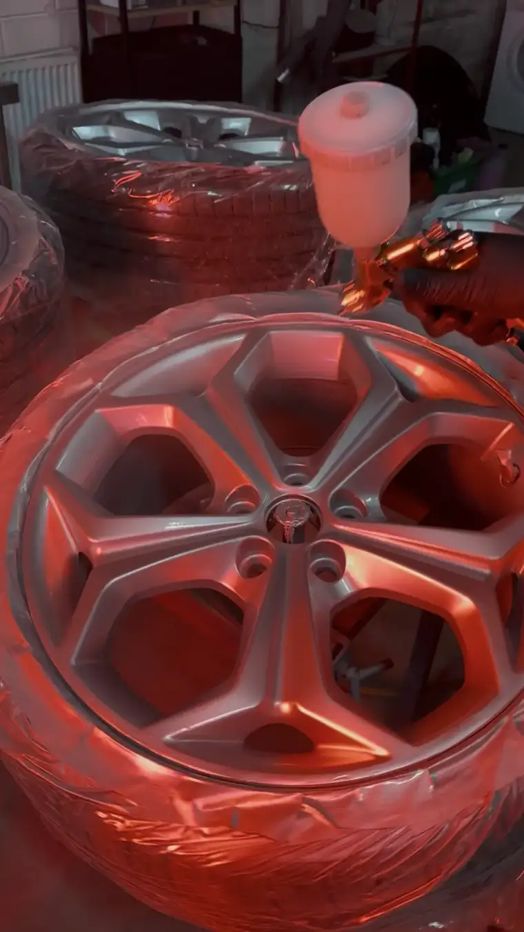 An alloy wheel being sprayed in the booth at B'Rimz