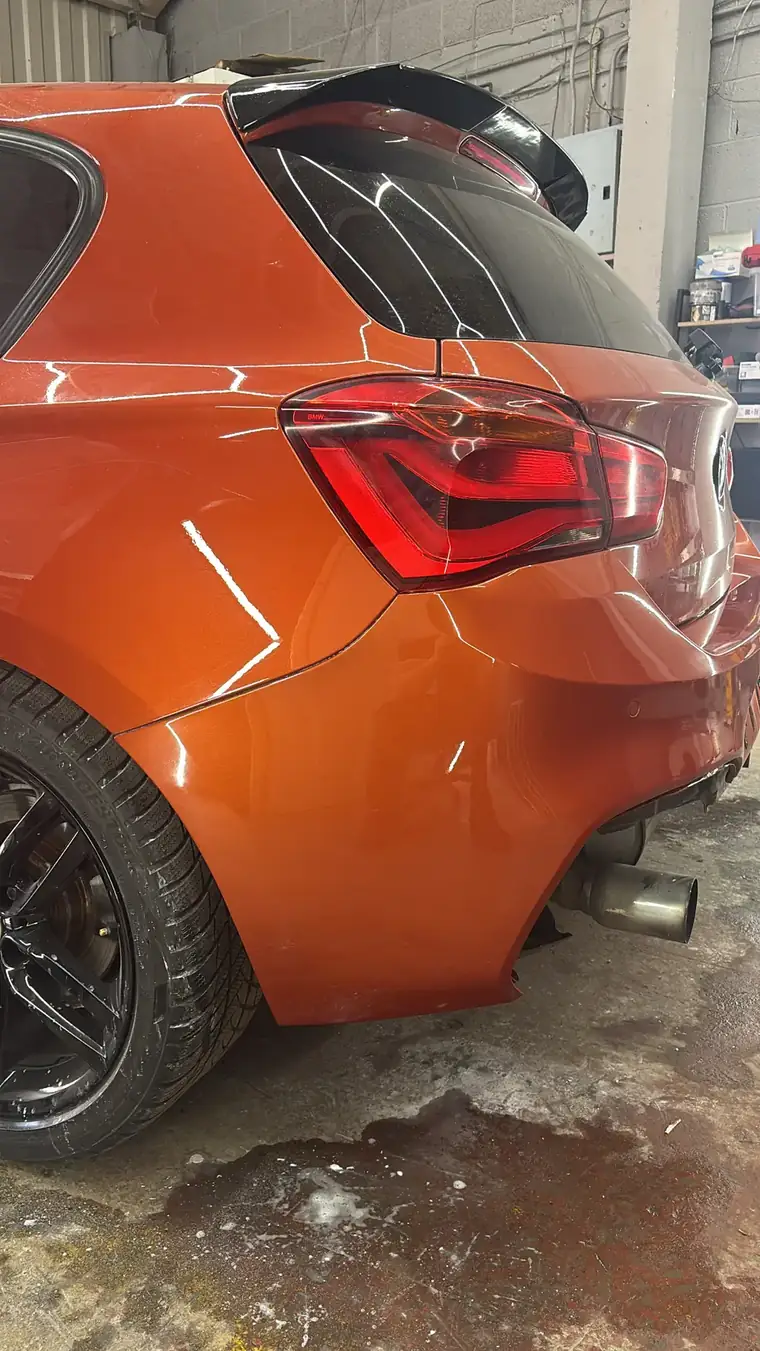 Orange BMW 1 Series rear quarter after a SMART repair