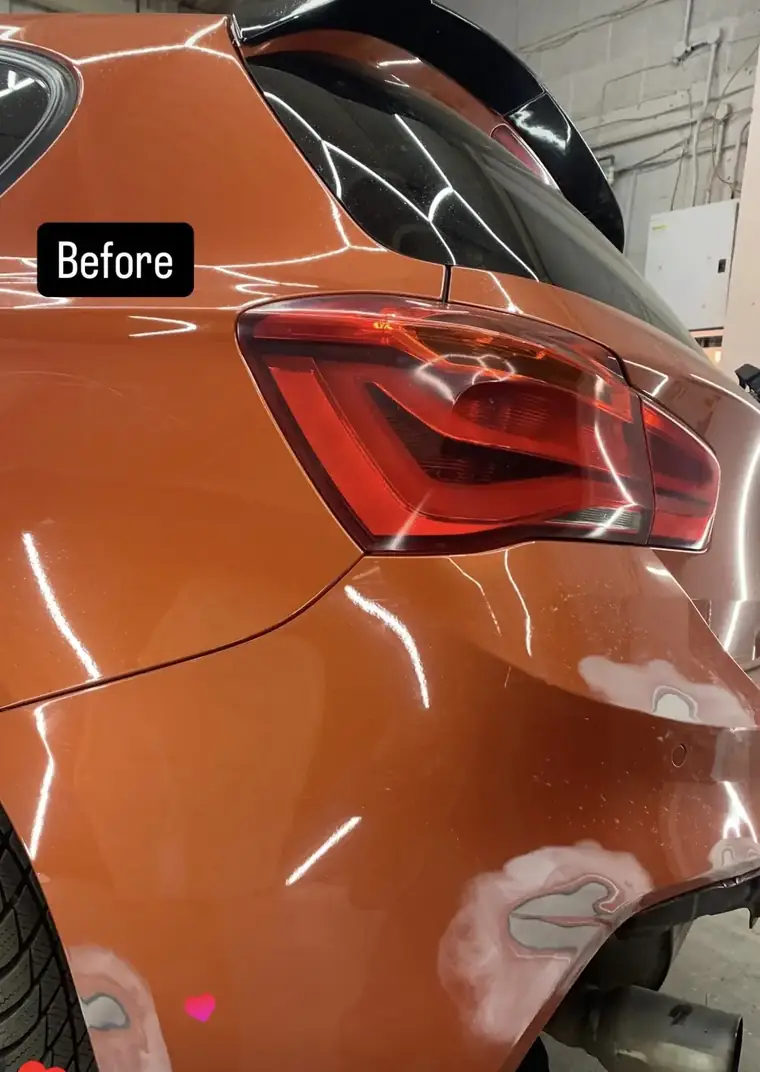 Orange BMW 1 Series rear quarter with primer patches before a SMART repair